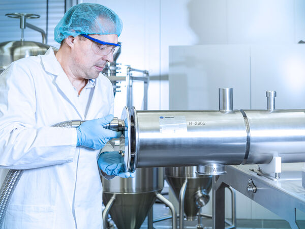 A worker conducting a factory acceptance test on a machine.
