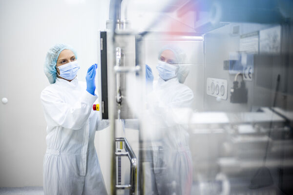 Person works in protective clothing in the pharmaceutical industry