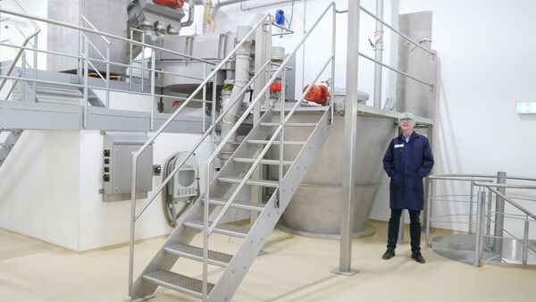 Man standing next to a Hosokawa Alpine mixer